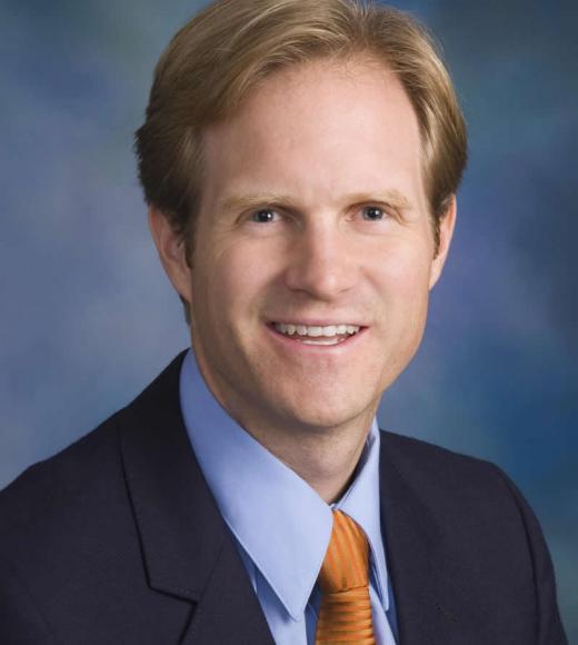 Man in suit posing for camera. 