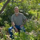 Man seated by a tree in a garden